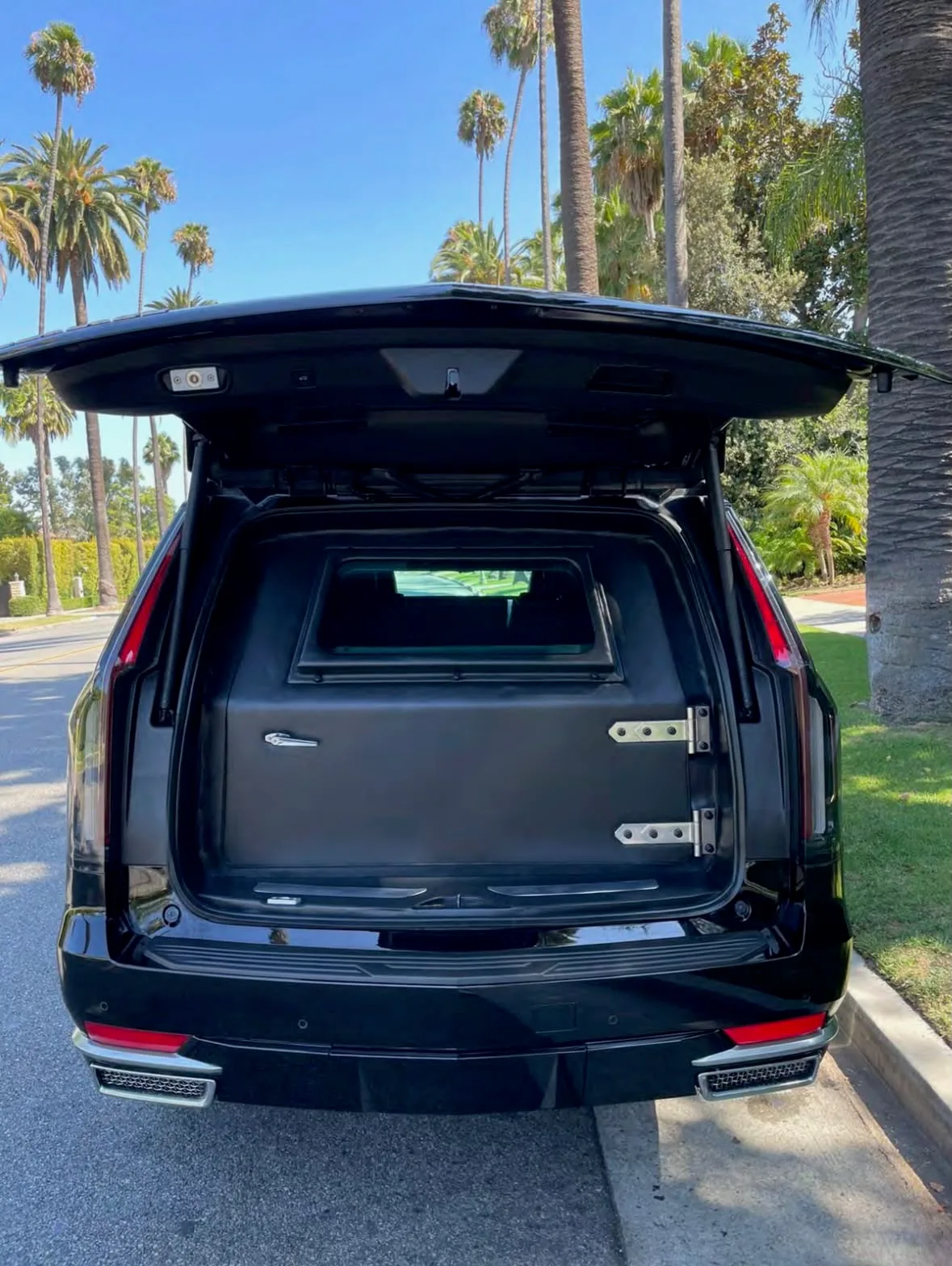 Armored Escalade — reinforced rear liftgate open with the ballistic barrier