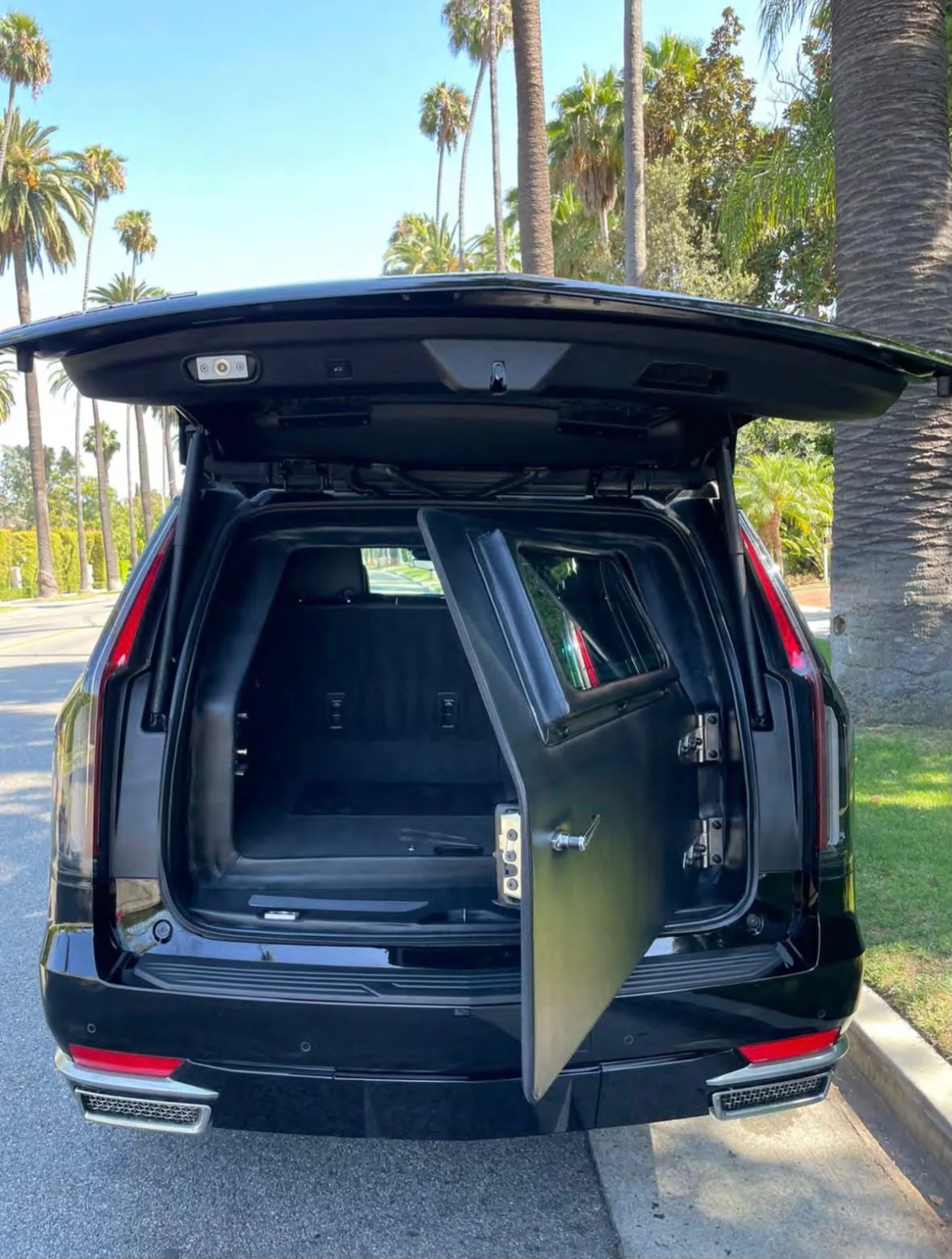 Armored Escalade — rear ballistic barrier door open to the cargo bay
